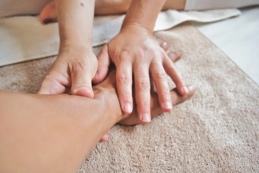 Therapist applying precise sustained pressure during a trigger point massage treatment