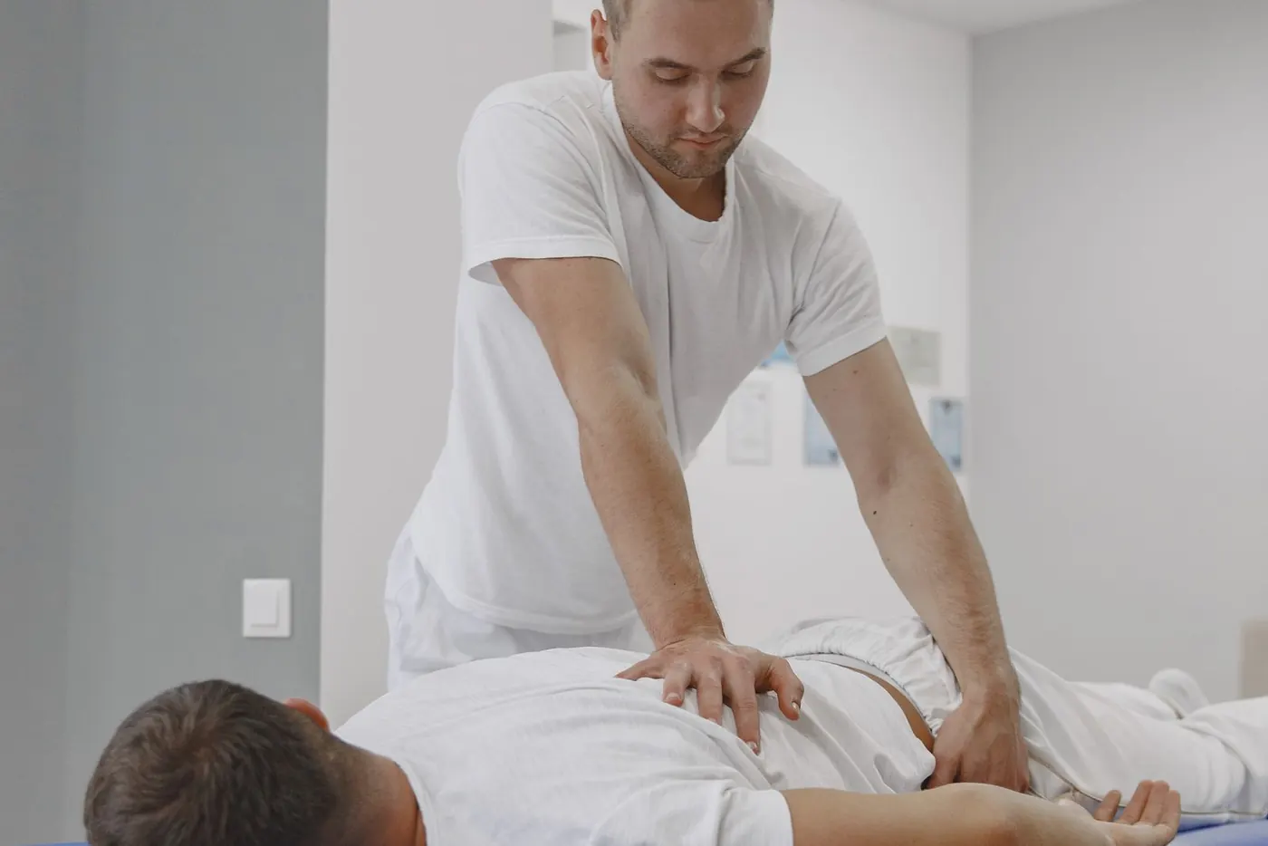 Massage therapist performing a clinical back treatment for pain relief